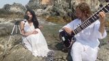 YoYo Sitar with a vocalist in performance on Goa beach.