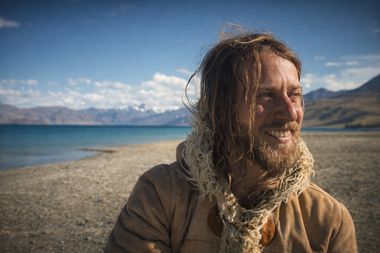 Windswept portrait of Yoav Fekete (YoYo Sitar) beside a high-altitude lake in Ladakh