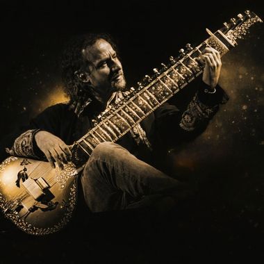 Yoav Fekete (YoYo Sitar) performing on sitar under a spotlight in a dramatic live stage portrait