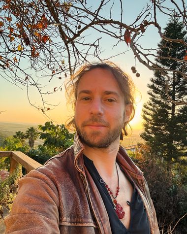 Outdoor golden-hour portrait of Yoav Fekete, the sitar artist known as YoYo Sitar